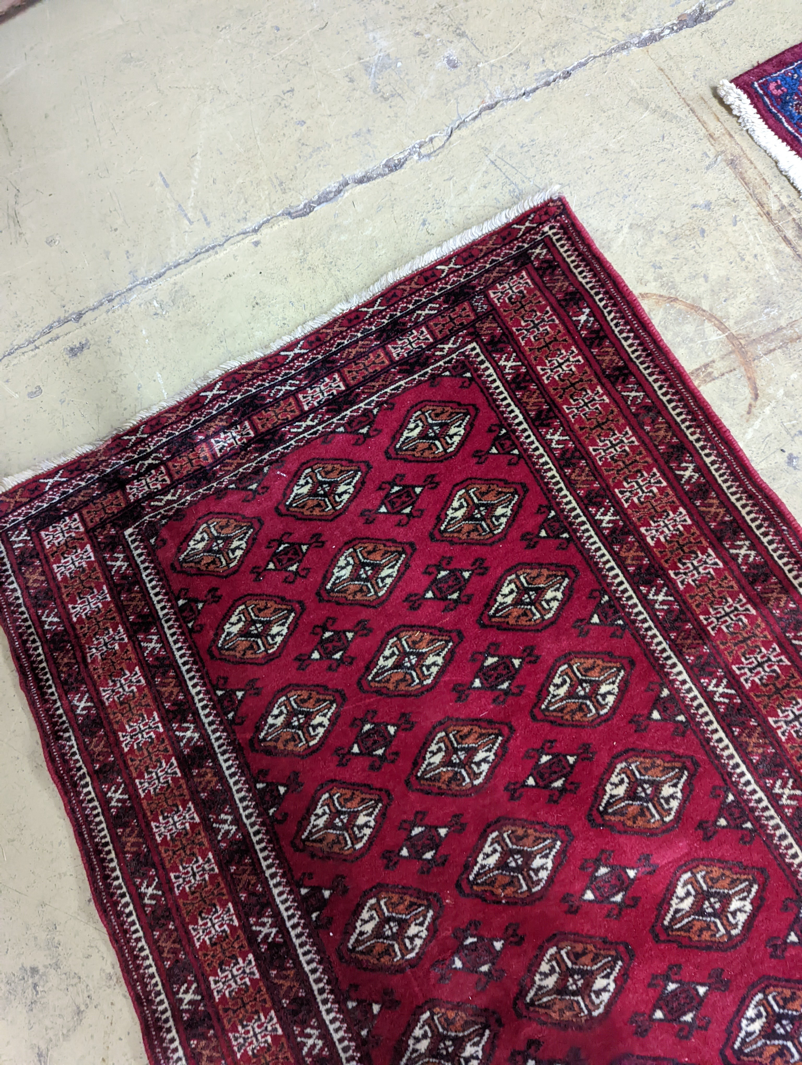 A Bokhara red ground runner, 364 x 98cm